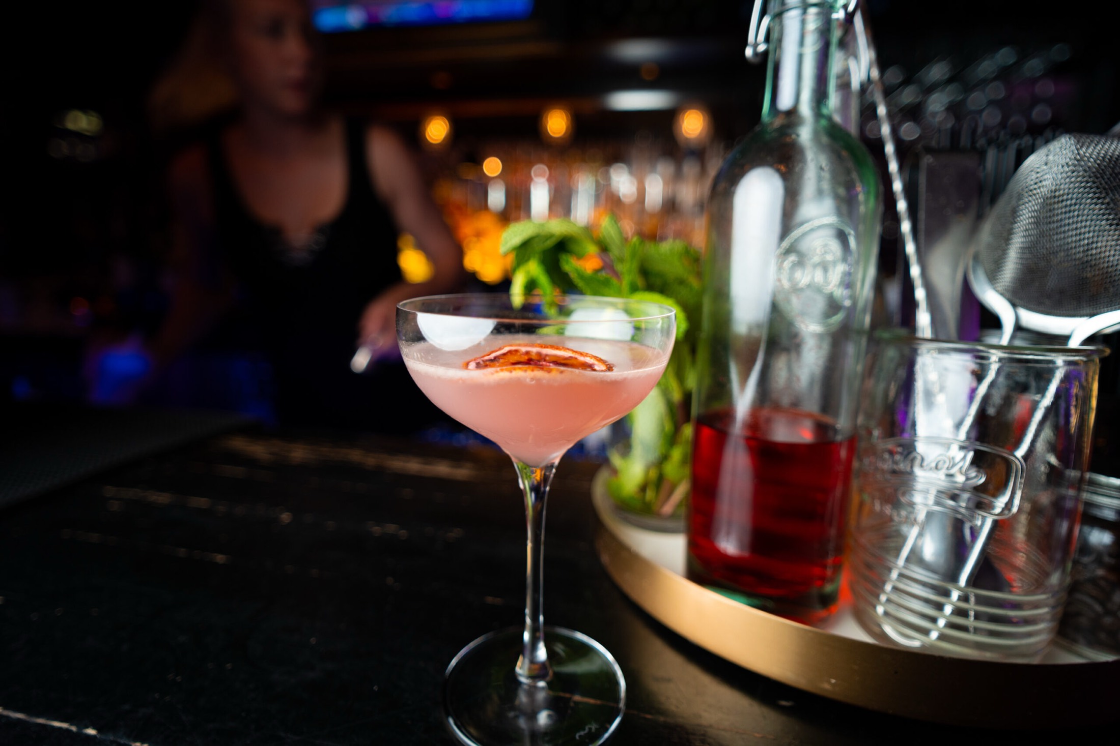 A pink coupe cocktail on the bar at Panáche