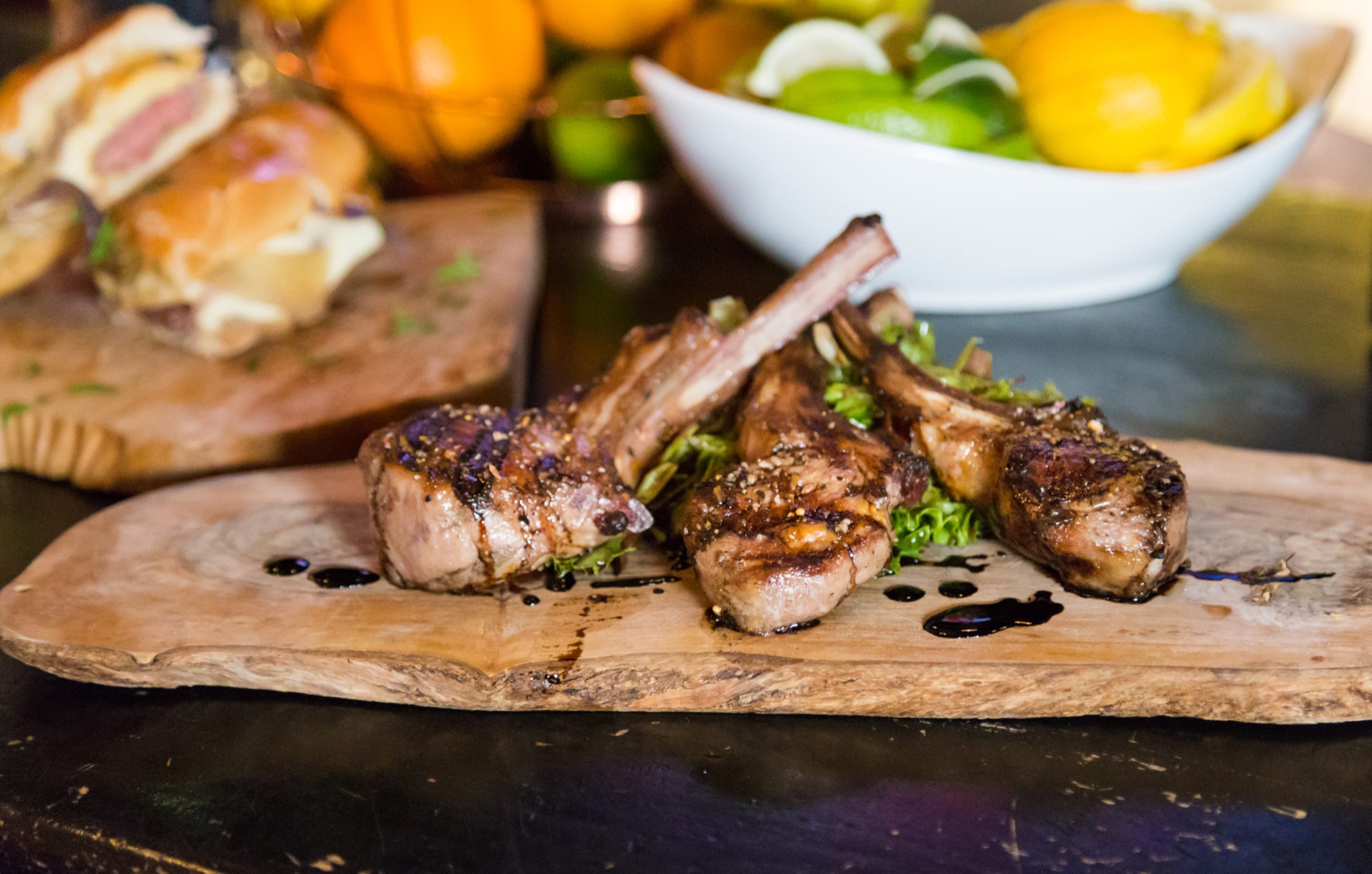 Lamb lollipops on a wooden board at Panáche